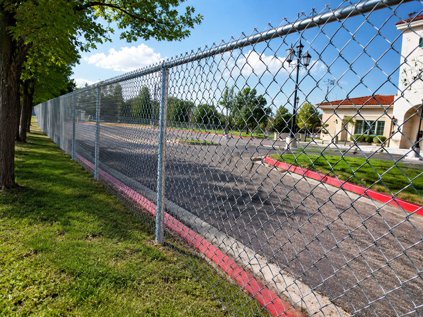 Galvanized chain link fence installed around a commercial property for secure perimeter fencing and long-lasting boundary protection.