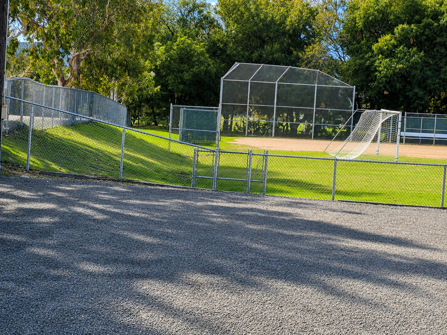 Galvanized chain link fence installed around a sports ground with secure perimeter fencing for schools and public parks.