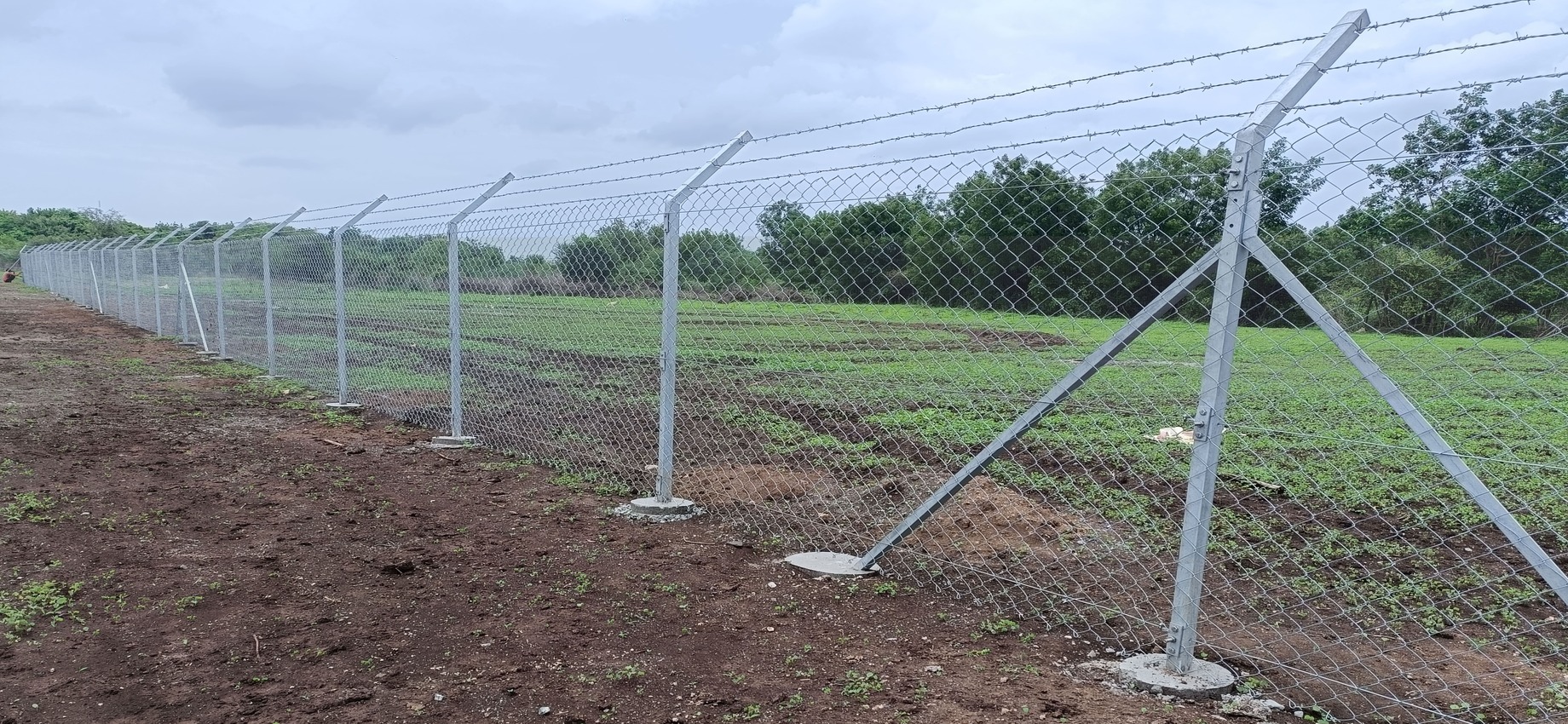 Solar power plant fencing with 6 feet galvanized chain link mesh and 3 rows of barbed wire